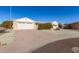 Single story home with a two car garage and mature shrubs at 9526 W Briarwood N Cir, Sun City, AZ 85351