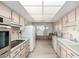 View of kitchen with wood flooring, white appliances, and ample counter space at 9526 W Briarwood N Cir, Sun City, AZ 85351