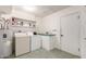 Laundry room with washer, dryer, and storage shelves at 9526 W Briarwood N Cir, Sun City, AZ 85351