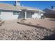 Large backyard with gravel landscaping, rock borders, and a covered patio at 9541 E Fairbrook St, Mesa, AZ 85207