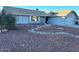 Landscaped front yard with rock garden and mature trees at 9541 E Fairbrook St, Mesa, AZ 85207