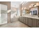 Elegant bathroom with double vanity, soaking tub, and walk-in shower at 9915 E Cinnabar Ave, Scottsdale, AZ 85258