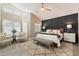 Main bedroom with a sitting area and large windows at 9915 E Cinnabar Ave, Scottsdale, AZ 85258