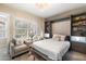 Guest bedroom with Murphy bed, built-in shelves, and window seating at 9915 E Cinnabar Ave, Scottsdale, AZ 85258