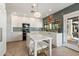 Modern kitchen boasts white cabinets, marble island, and stylish backsplash at 9915 E Cinnabar Ave, Scottsdale, AZ 85258