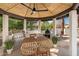 Outdoor kitchen and dining area with built-in grill and wood-fired pizza oven at 9915 E Cinnabar Ave, Scottsdale, AZ 85258