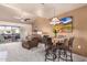 Bright dining area with table and chairs, view to living room and patio at 9990 N Scottsdale Rd # 2048, Paradise Valley, AZ 85253