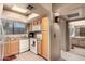 Condo kitchen featuring light wood cabinets and white appliances at 9990 N Scottsdale Rd # 2048, Paradise Valley, AZ 85253