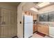 Cozy condo kitchen with light wood cabinets and appliances at 9990 N Scottsdale Rd # 2048, Paradise Valley, AZ 85253