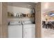 Stackable washer and dryer in a well-lit laundry closet at 9990 N Scottsdale Rd # 2048, Paradise Valley, AZ 85253