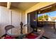 Glass-top patio table with wicker chairs, overlooking a courtyard at 9990 N Scottsdale Rd # 2048, Paradise Valley, AZ 85253