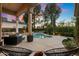 Inviting backyard with a sparkling pool, patio furniture, and lush landscaping at 11748 N 80Th Pl, Scottsdale, AZ 85260