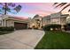 Stunning curb appeal, this home features a large driveway and lush landscaping at 11748 N 80Th Pl, Scottsdale, AZ 85260