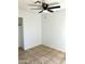 Simple bedroom with ceiling fan and tile flooring at 10240 N 65Th Ln, Glendale, AZ 85302