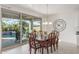 Bright dining room with wooden table and chairs, view of backyard pool at 10333 E Tahoe Ave, Mesa, AZ 85212