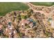 Aerial of desert home showcasing pools, lush landscaping, and tile roof at 10420 E Morning Vista Ln, Scottsdale, AZ 85262