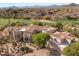 View of large Southwestern home showcasing desert landscaping, tile roof, and neutral-toned exterior at 10420 E Morning Vista Ln, Scottsdale, AZ 85262