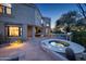 Luxury home with a spa, outdoor kitchen, and seating area at 10420 E Morning Vista Ln, Scottsdale, AZ 85262