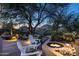 Relaxing patio with fire pit and seating area, perfect for enjoying desert evenings at 10420 E Morning Vista Ln, Scottsdale, AZ 85262