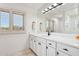 Well-lit bathroom features marble countertops, ample cabinet space, and a large mirror at 10420 E Morning Vista Ln, Scottsdale, AZ 85262