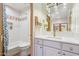 Bathroom with white cabinets, marble countertop, and modern light fixture at 10420 E Morning Vista Ln, Scottsdale, AZ 85262