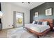 Stylish bedroom featuring a dark accent wall, light wood floors, and ample natural light at 10420 E Morning Vista Ln, Scottsdale, AZ 85262