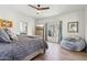 Bright bedroom with wood floors, a large window, and a comfortable sitting area at 10420 E Morning Vista Ln, Scottsdale, AZ 85262