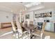 Spacious dining room with a wine bar and seating for six under modern lighting at 10420 E Morning Vista Ln, Scottsdale, AZ 85262