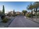 Long driveway leading to a luxurious desert home with landscaping at 10420 E Morning Vista Ln, Scottsdale, AZ 85262