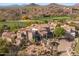View of large Southwestern home showcasing desert landscaping, tile roof, and neutral-toned exterior at 10420 E Morning Vista Ln, Scottsdale, AZ 85262