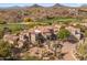 View of large Southwestern home showcasing desert landscaping, tile roof, and neutral-toned exterior at 10420 E Morning Vista Ln, Scottsdale, AZ 85262