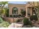 Side view of home with stone landscape features and desert plants at 10420 E Morning Vista Ln, Scottsdale, AZ 85262