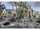 Stunning property exterior, showcasing a charming casita and lush landscaping at 10420 E Morning Vista Ln, Scottsdale, AZ 85262