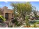 Desert landscaped front entrance with stone steps and mature trees at 10420 E Morning Vista Ln, Scottsdale, AZ 85262