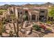 Attractive home with desert landscaping and a stone walkway leading to the front door at 10420 E Morning Vista Ln, Scottsdale, AZ 85262