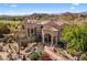 Close up exterior view showing front entrance with desert landscaping, large windows and tile roof at 10420 E Morning Vista Ln, Scottsdale, AZ 85262