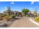 Expansive desert-landscaped property with winding driveway, and attached garage at 10420 E Morning Vista Ln, Scottsdale, AZ 85262