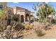 Lush desert front yard with cacti, boulders, and a charming walkway to the entrance at 10420 E Morning Vista Ln, Scottsdale, AZ 85262