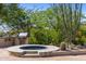 Custom outdoor hot tub surrounded by mature landscaping at 10420 E Morning Vista Ln, Scottsdale, AZ 85262