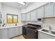 Well-equipped laundry room with modern washer/dryer, stylish cabinets, and ample counter space at 10420 E Morning Vista Ln, Scottsdale, AZ 85262