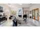 Relaxing living area featuring a fireplace, comfortable seating, and French doors for natural light at 10420 E Morning Vista Ln, Scottsdale, AZ 85262