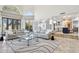 Bright living room with high ceilings seamlessly connects to a modern kitchen with an island at 10420 E Morning Vista Ln, Scottsdale, AZ 85262
