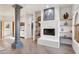 Bright main bedroom showcasing a white fireplace, decorative column, and access to the closet at 10420 E Morning Vista Ln, Scottsdale, AZ 85262