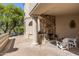 Outdoor fireplace with chairs and stone patio, perfect for relaxing at 10420 E Morning Vista Ln, Scottsdale, AZ 85262