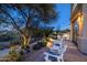 Elegant patio with seating area, landscape lighting, and desert views at 10420 E Morning Vista Ln, Scottsdale, AZ 85262
