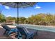 Inviting pool with lounge chairs and desert landscape views, perfect for relaxation at 10420 E Morning Vista Ln, Scottsdale, AZ 85262