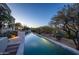 Stunning infinity pool with a view of the desert landscape at sunset at 10420 E Morning Vista Ln, Scottsdale, AZ 85262