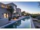Expansive infinity pool and patio with desert landscape and sunset view at 10420 E Morning Vista Ln, Scottsdale, AZ 85262