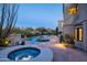 Stunning pool and spa surrounded by a beautifully landscaped yard at 10420 E Morning Vista Ln, Scottsdale, AZ 85262