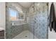 Close up of tiled shower featuring glass door and brushed nickel hardware at 10420 E Morning Vista Ln, Scottsdale, AZ 85262